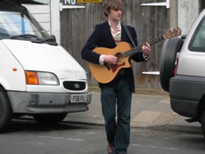 Ali Warren plays guitar