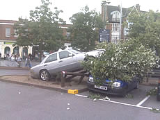 car on fence outside Morrisons in Acton