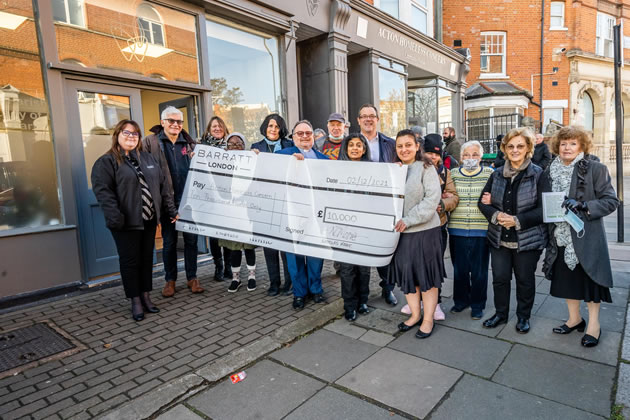 Volunteers at Acton Homeless Concern with a large cheque