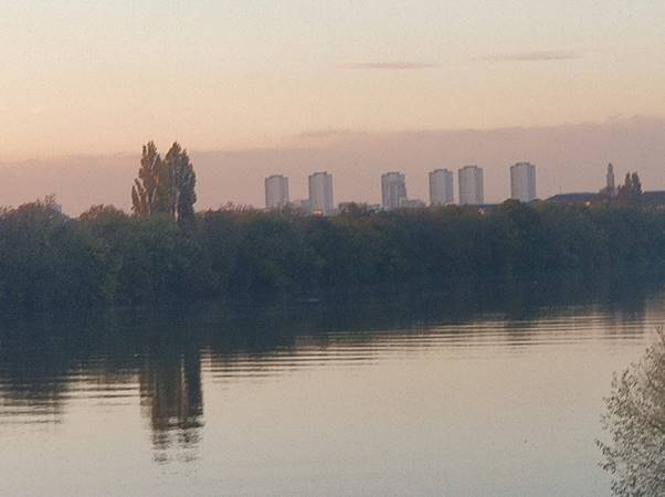 A body of water with a city in the background  Description automatically generated