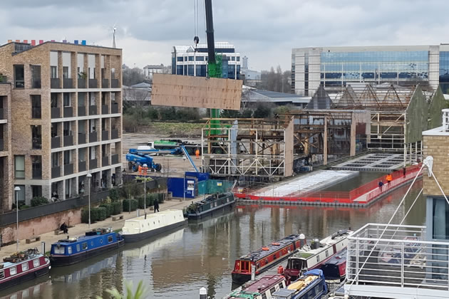 A panel is lifted from the warehouse on Commerce Road, Brentford