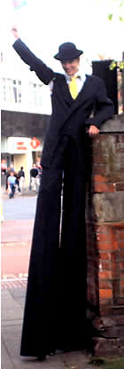 stilt walker handing out leaflets