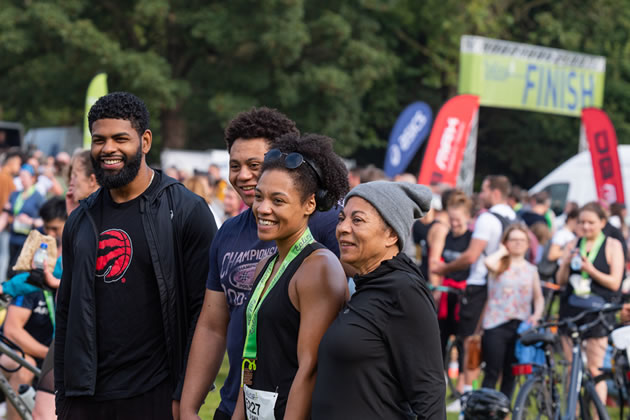 An Ealing Half finisher celebrates with her family 