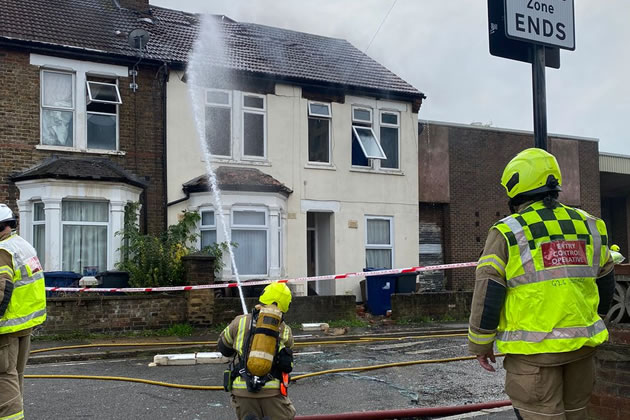 Firefighters damp down the house on North Road