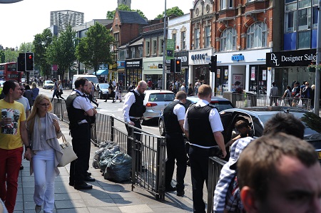 police inspecting damage after items thrown