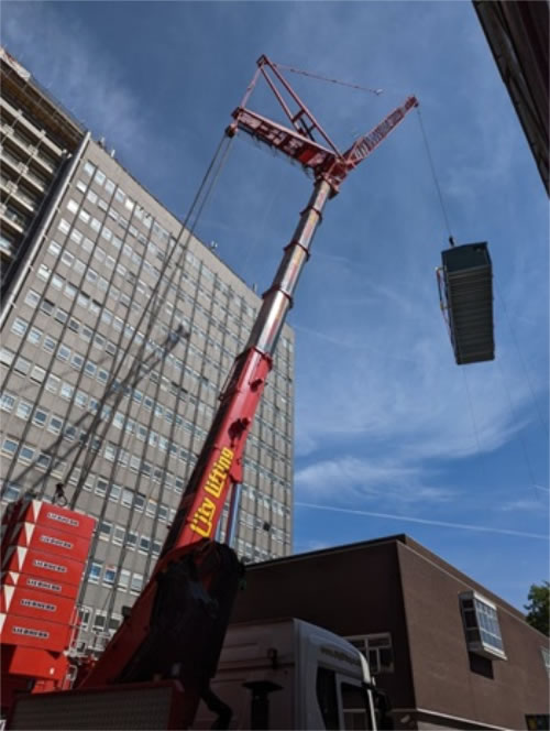 The crane lifting up the heat pump unit 