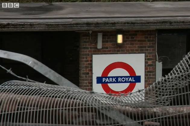 A mangled fence in front of Park Royal Station