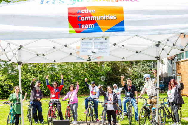 Southall residents celebrating getting their free bikes 